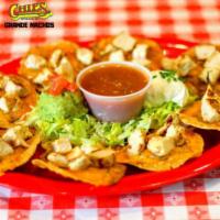 Grande Nachos · 8 large tostadas topped with beans, cheese and your choice of chicken, beef or pork. Garnish...
