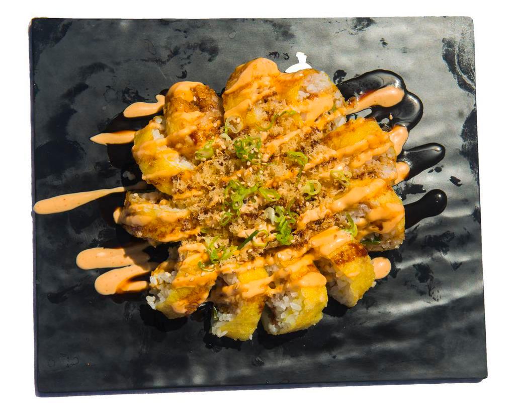 H-04. Hot Mama Roll · Tempura-fried roll with soft-shell crab, jalapeno, and cream cheese topped with tempura flakes, spicy mayo, eel sauce, sesame seeds, scallions.