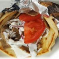 Gyro Wrap · Warm pita wrapped around choice of meat (beef, lamb, chicken, or falafel) with tomatoes and ...
