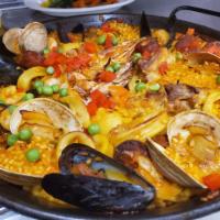 Paella Marinera Americana · Saffron long grain rice, shrimp, clams, mussels, scallops and calamari, with a North America...