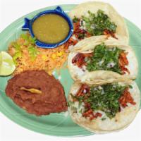 Tacos al Pastor · Pork marinated in our savory red sauce topped with cilantro and onion.