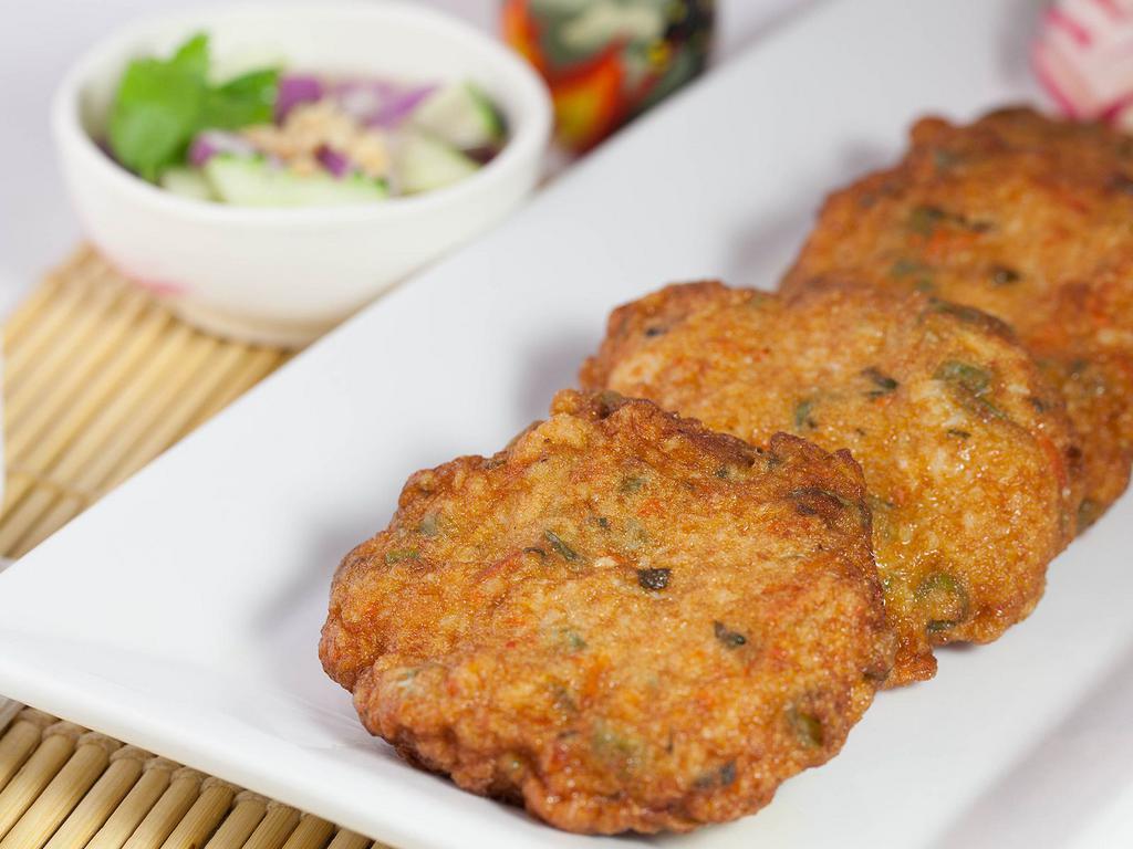 Chicken Cakes · Mixture of spices, chicken, green beans, and kaffir leaves deep fried and served with cucumber sauce.

