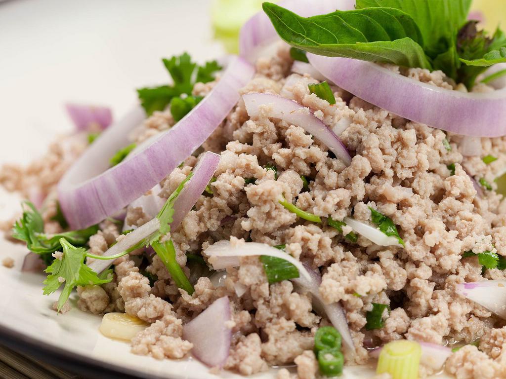 Ground Meat Salad · Cooked ground chicken or ground pork marinated in lime juice, onions, basil, herbs, and spices. Served with a side of cabbage. 
