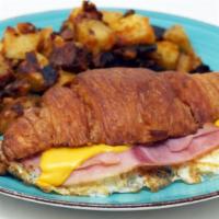 Croissant Breakfast Sandwich · 2 fried eggs,ham and swiss cheese with home fries