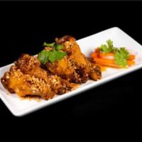 Chicken Wings · Crispy chicken wings caramelized in house garlic fish sauce.