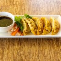 Pot Sticker · Crispy chicken and vegetables pot stickers, served with house dumpling sauce
