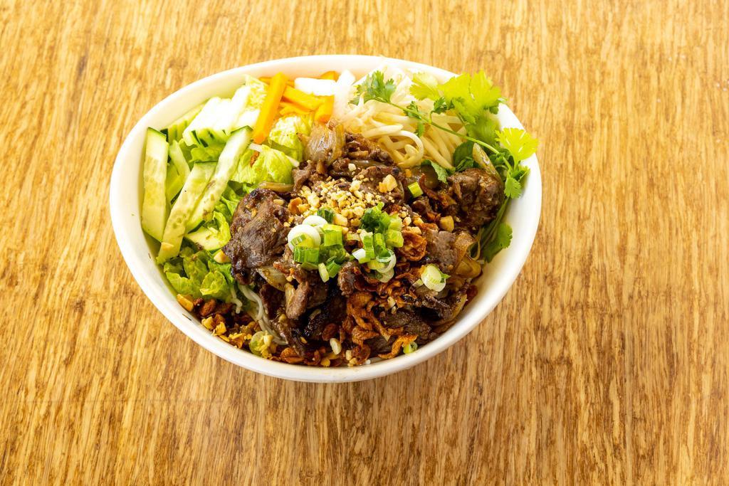 Ginger Beef Stir-Fry Bowl · Beef, ginger, onion fresh herbs, cucumber, pickled vegetables, topped with crispy shallots and crushed peanuts, served with fish sauce.