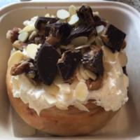 Nutty Buddy Cinnamon Roll · Peanut butter frosting topped with almonds, peanut butter cups and walnuts.