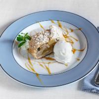 Apple Strudel · Apples, almonds & raisins baked with spices in a flaky pastry crust: fresh whipped cream and...