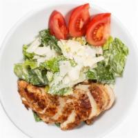 Chicken Caesar Salad · Romaine lettuce, tomatoes, croutons, Parmesan cheese and housemade Caesar dressing.