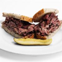 Hot Pastrami Sandwich · Piled high on rye bread. Served with a kosher dill pickle spear and french fries.
