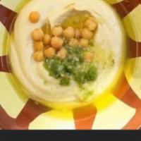 Hummus · A delightful dip of pureed garbanzo beans, blended with tahini and lemon. Topped with extra ...