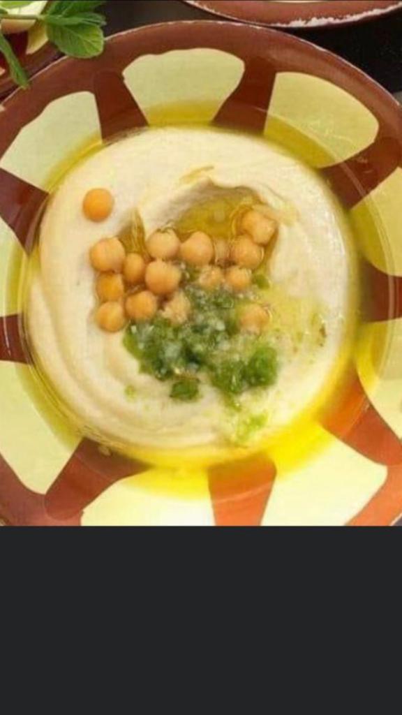 Hummus · A delightful dip of pureed garbanzo beans, blended with tahini and lemon. Topped with extra virgin olive  Vegan