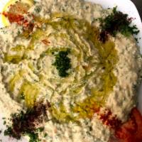 Hummus Beiruti Style · A spicy version of our hummus, a delightful dip of pureed garbanzo beans, blended with tahin...