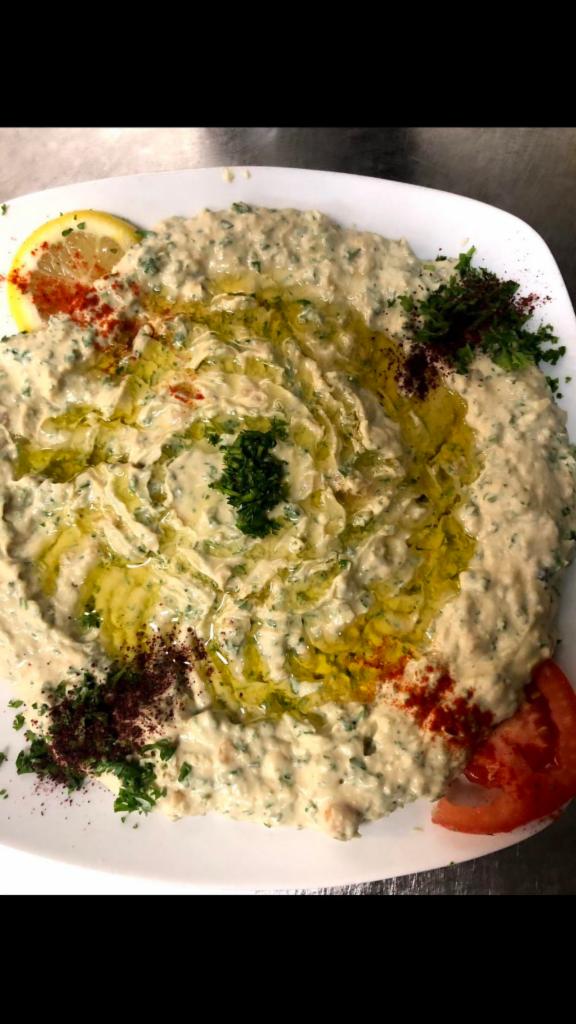 Hummus Beiruti Style · A spicy version of our hummus, a delightful dip of pureed garbanzo beans, blended with tahini and lemon. Topped with extra virgin olive oil. Vegan. Gluten free.