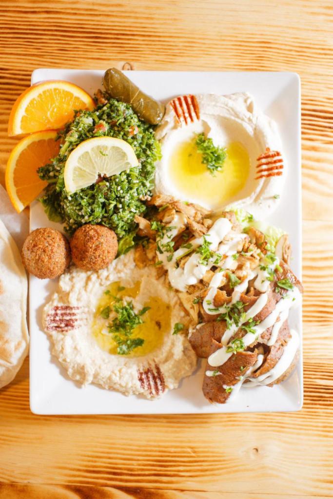 Meat Mezza Sampler · A variety of our appetizers. Includes hummus, baba ghanouj, rolled grape leaves, tabouli salad, falafel, chicken shawarma and gyro meat. Halal meat.  No substitutions please.
