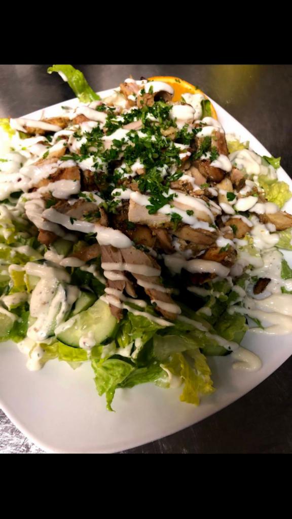 Chicken Shawarma Salad · Fresh lettuce and chicken shawarma with garlic sauce, tomato and cucumbers. Mixed with our house salad dressing.