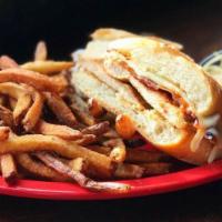 The Hacksaw Sandwich · Grilled chicken with your choice of sauce, melted mozzarella and bacon on garlic bread. Serv...