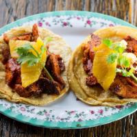 Al Pastor de Pollo Tacos · Spit roasted chicken marinated in chile guajillo, charred pineapple and cilantro. Gluten free.