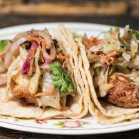 2 Fried Chicken Tacos · Baja style beer-battered chicken, smoked cabbage slaw, and ghost pepper mayo.