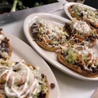 3 Sopes · Served with re-fried black beans, lettuce, queso fresco, sour cream and your choice of meat.