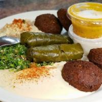 Vegetarian Combo · A sampling of favorites! Hummus, tabouli, baba gannouj, falafel, and dawali served with tahi...