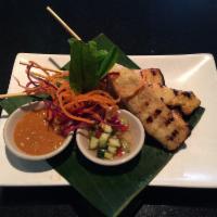 Chicken Satay · Grilled marinated chicken tender on skewers served with cucumber relish and peanut sauce.