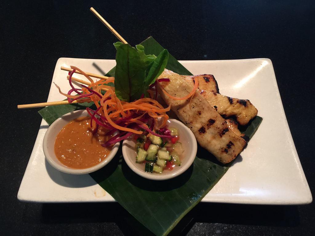 Chicken Satay · Grilled marinated chicken tender on skewers served with cucumber relish and peanut sauce.