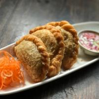 Curry Puff · Combination of chicken, potatoes and onions with curry powder in a puff pastry served with a...