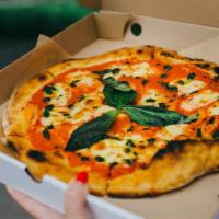 Pizza Margherita · Extra thin crust covered with mozzarella, seasoned tomatoes and fresh basil leaves.