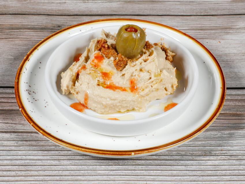 Hummus · Chickpea paste and tahini sauce topped with olive oil and paprika.