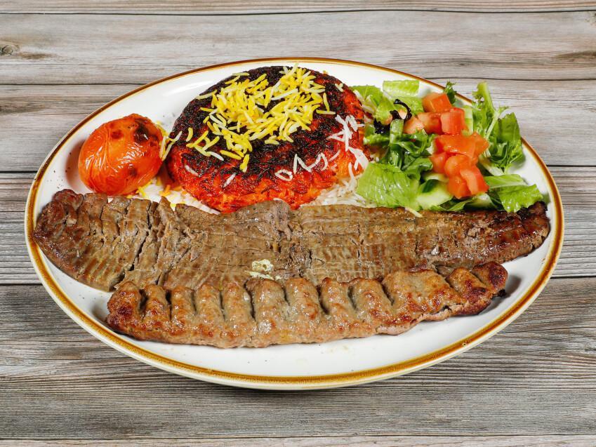 Soltani · 1 skewer of seasoned mixed ground beef and lamb and 1 skewer of marinated beef fillet with grilled tomato served with tahdig rice.