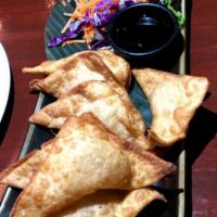 7. Crab Rangoon · Eight pieces. Deep fried imitation crab meat and cream cheese wrapped in wonton skins, serve...