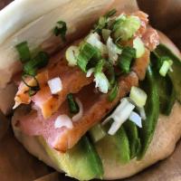 Smoked Salmon · Smoked salmon wrapped in a fluffy, steamed bun.  Served with a spread of cream cheese on a b...