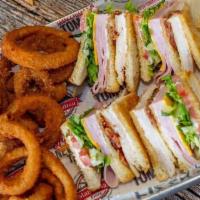 Manhattan Club Sandwich · Triple decker sandwich with ham, roasted turkey breast, Swiss and American cheese, bacon, le...