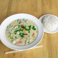 Large Thom Kha Soup · Creamy hot and sour coconut soup with mushrooms, tomatoes, onions, cilantro, lime leaves, le...
