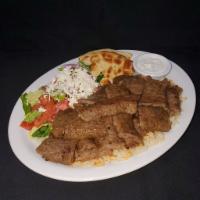 Lamb Gyro Platter · Spit roasted layers of marinated beef and lamb. Served with rice, Greek salad, and the Host'...