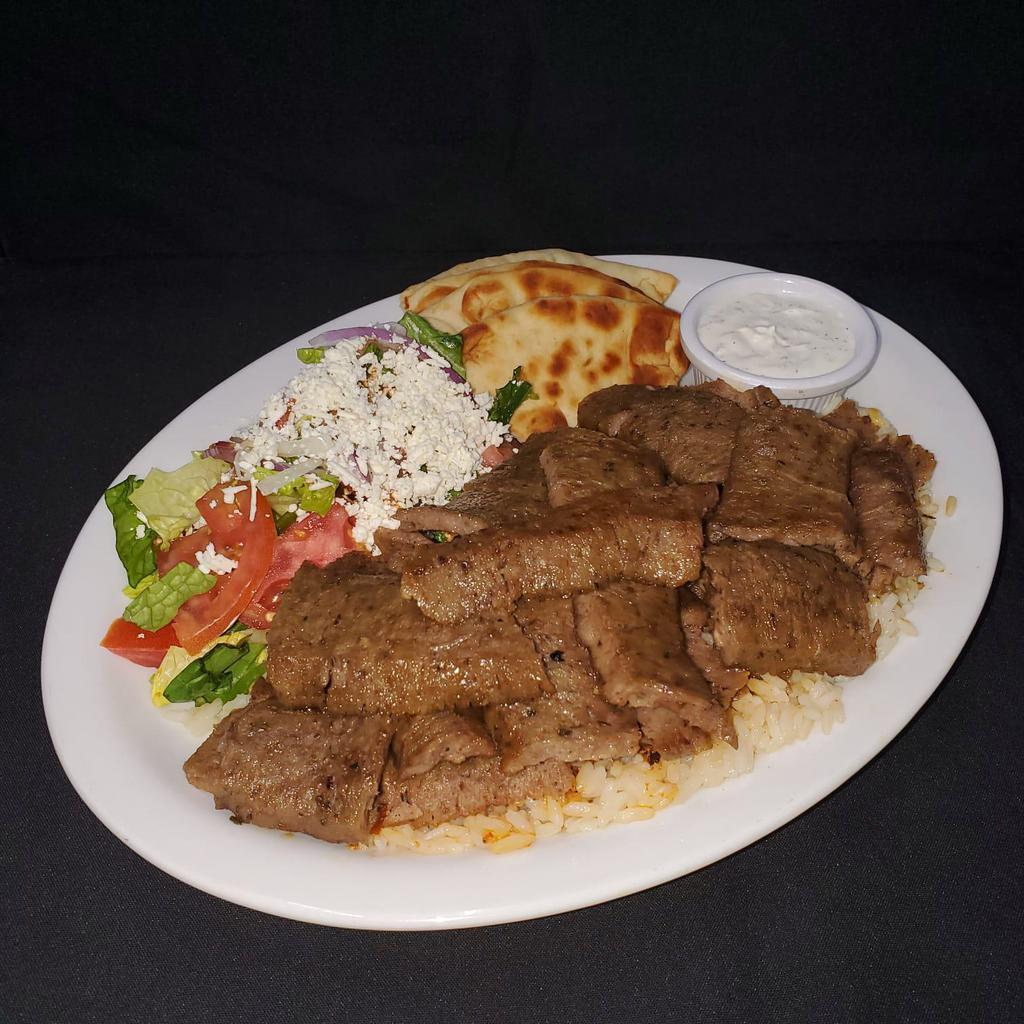 Lamb Gyro Platter · Spit roasted layers of marinated beef and lamb. Served with rice, Greek salad, marinated pita, and tzatziki sauce.