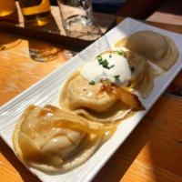 pierogies · Potato stuffed dumplings, caramelized onion and sour cream.