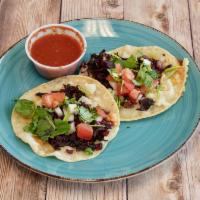 Flor de Jamaica Taco · 2 corn tortillas grilled with vegetarian jamaica flower, cheese, onion, tomato and cilantro....