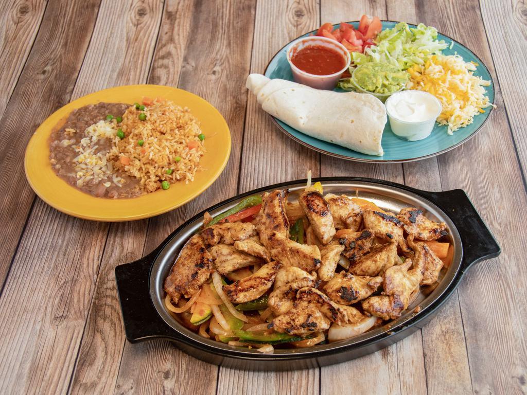 Fajitas Dinner · Choice of meat, grilled veggies, meat with beans and rice. On the side comes 4 flour tortillas, lettuce, tomato, cheese, sour cream and guacamole.  Comes with a medium/hot salsa unless a mild salsa is requested.