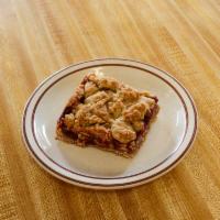 Raspberry Bar · large brown sugar oatmeal cookie base filled with raspberry filling