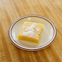 Lemon Bar · Large shortbread cookie base topped with luscious lemon curd filling and dusted with powdere...