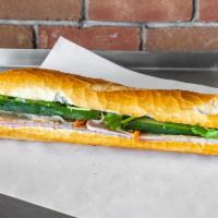 21. Ham and Turkey Sandwich on Baguette · Ham and turkey with pickled veggies, cilantro, jalapeno, mayo and sauces.