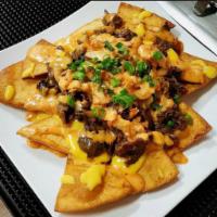 Joint Nachos · Korean BBQ, kimchi, onions, cheese with spicy aioli and tortilla chips.