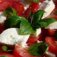 Caprese Salad · Fresh plum tomatoes, fresh mozzarella and basil with your choice of dressing.