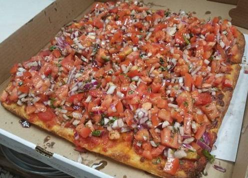 Bruschetta Pizza · Thin crust square pizza topped with marinated fresh tomatoes, basil and onions.