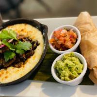 Queso Fundido · Oaxaca and Monterey cheese baked casserole served with corn tortillas, pico de gallo, and fr...