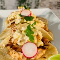 Tacos de Pollo asado · Marinated  grilled chicken thighs topped off with esquites(corn kernels, epazote, Mexican ma...