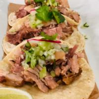 Tacos de Carnitas · Slow braised pork, tomatillo pico de gallo, crispy pork skin.
